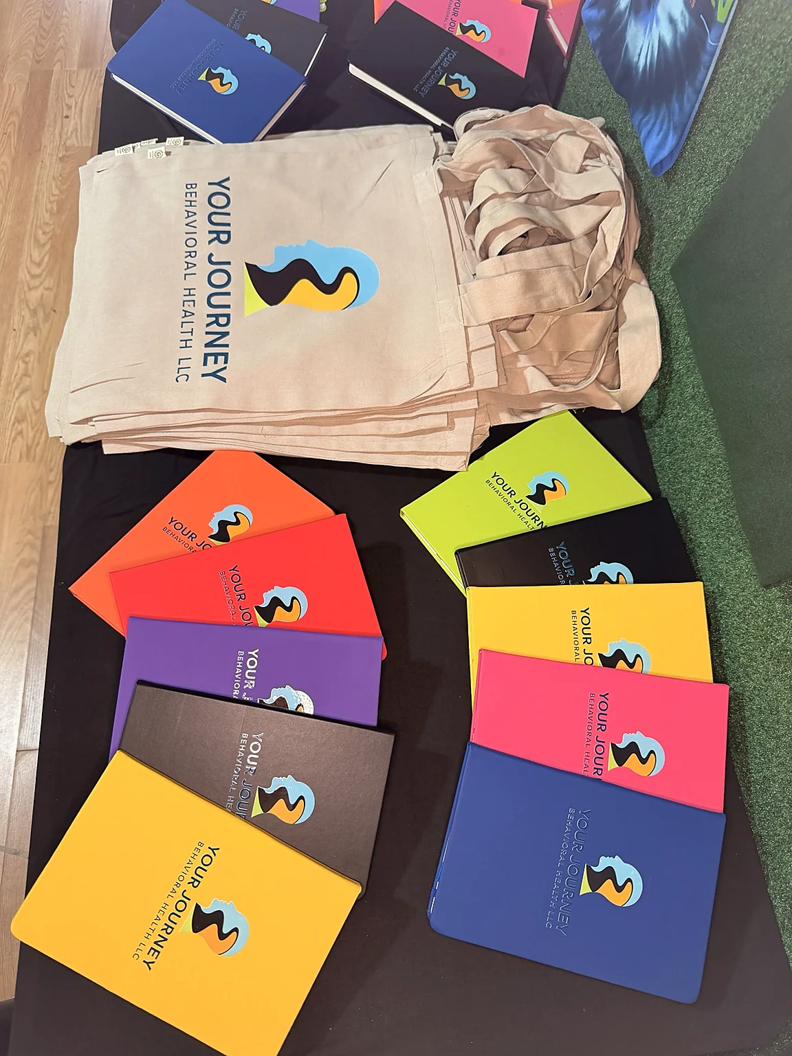 Colorful behavioral health notebooks and custom tote bags