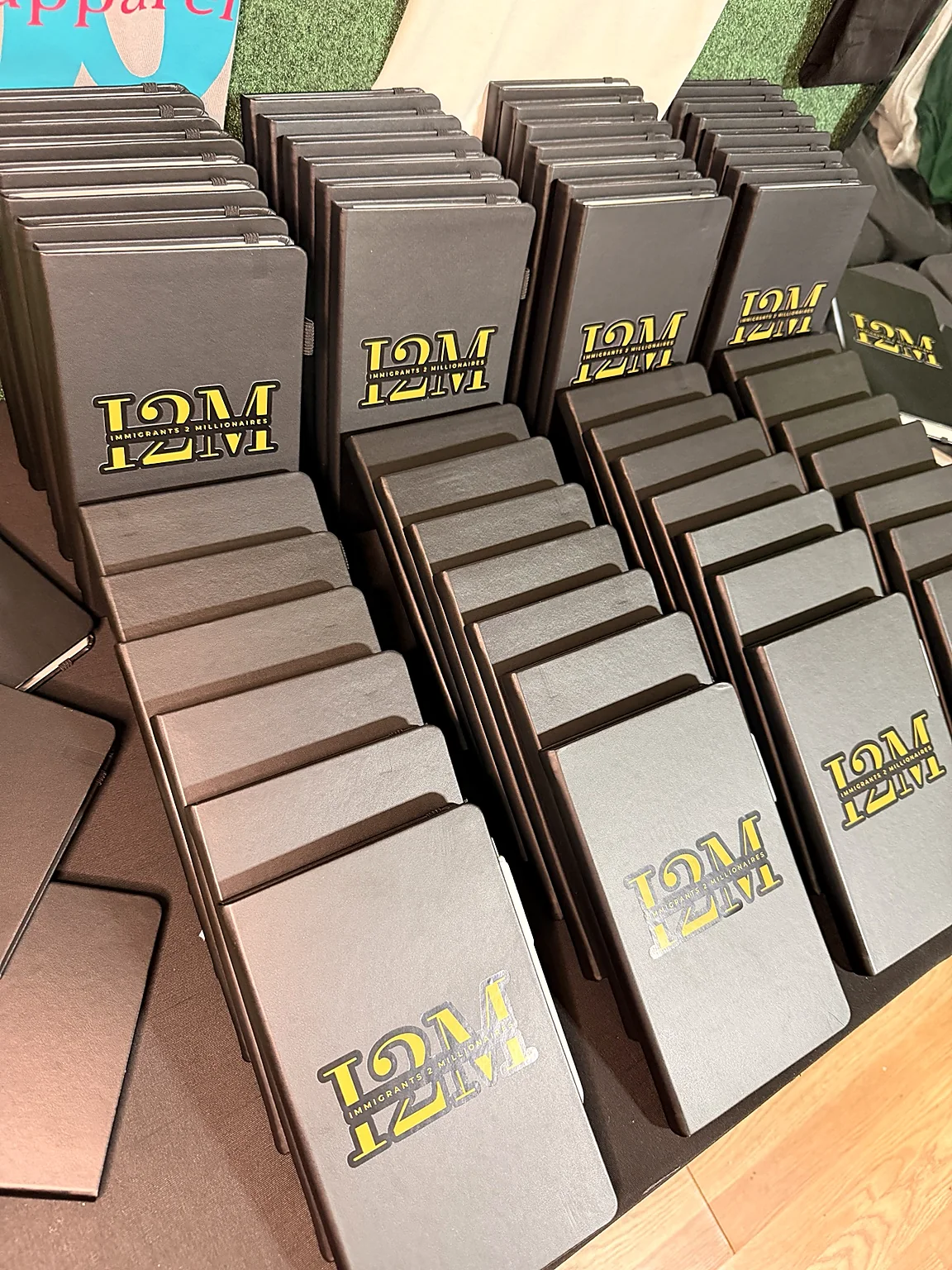 Rows of black corporate notebooks with custom gold branding