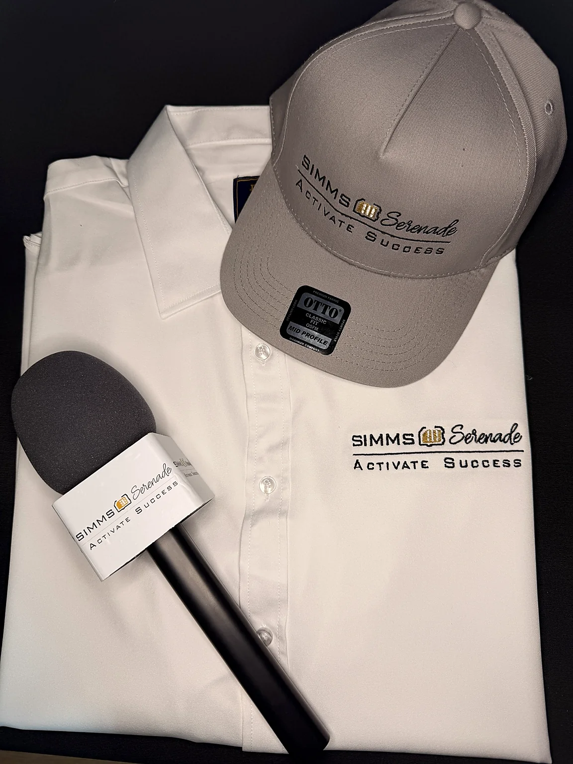 White embroidered business shirt and cap with a branded microphone